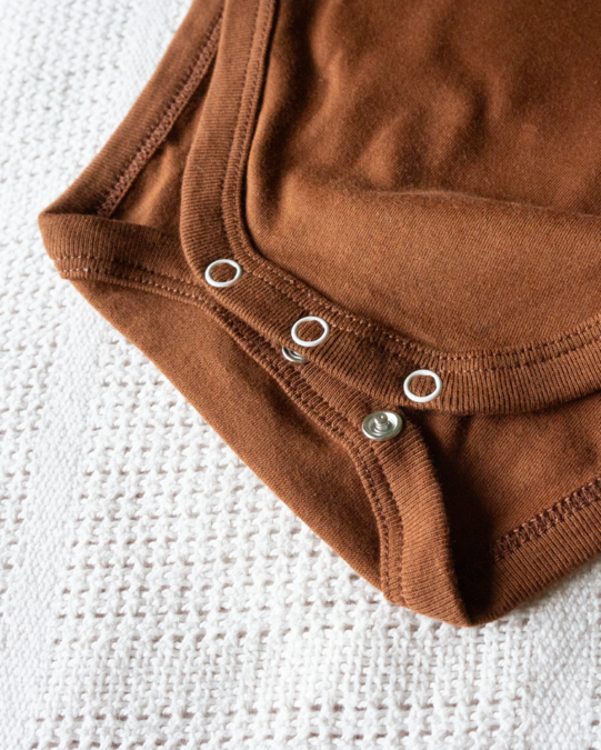 LIMAU short sleeve bodysuit features press-studs at the crotch for easy nappy changes.